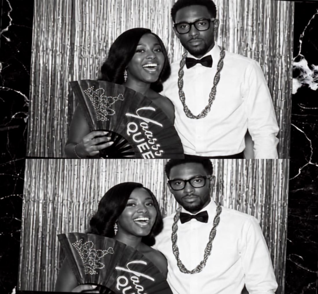 A black-and-white photo booth strip of a couple with a Yaasss Queen fan